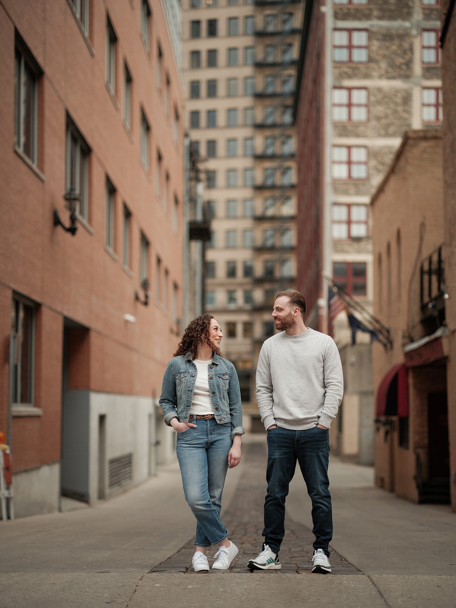 couple stands near alley in milwaukee