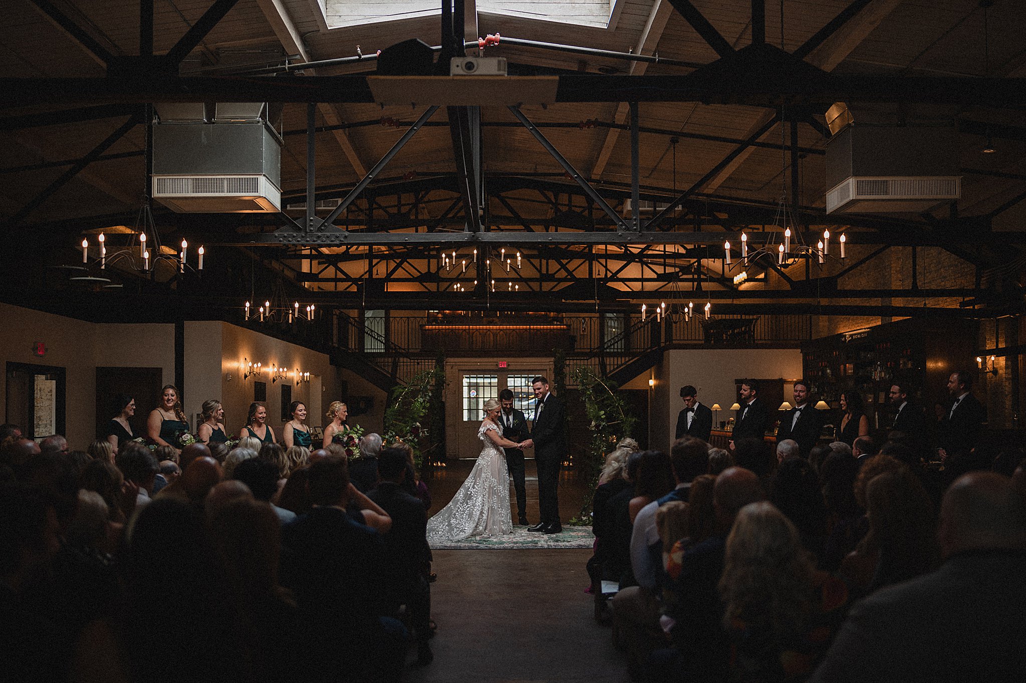 gibson social club wedding with married couple standing under skylight