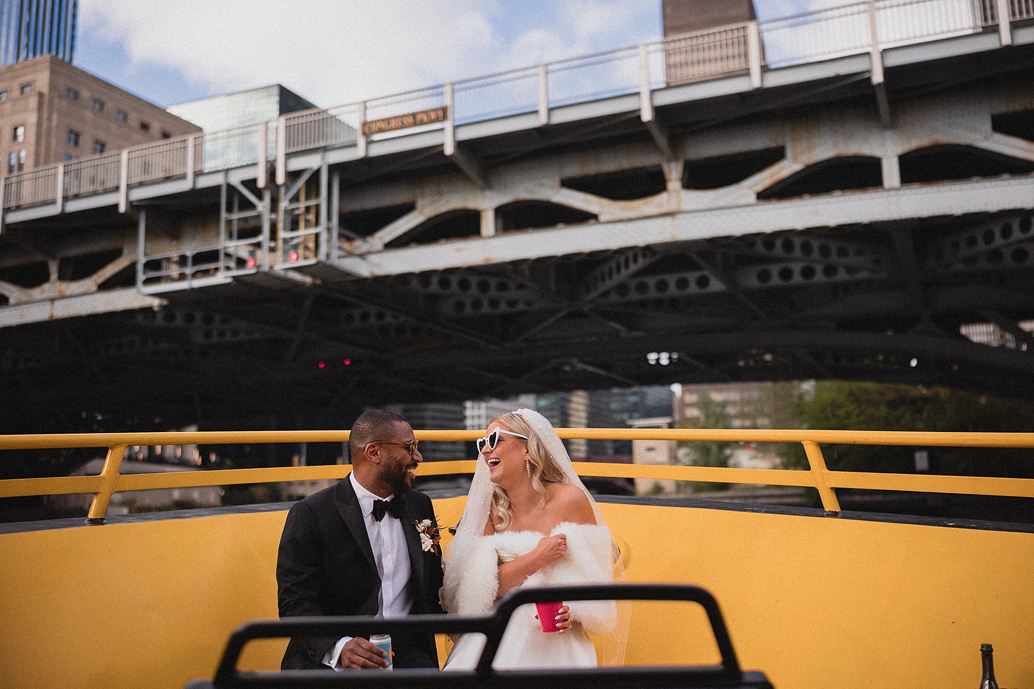 couple on chicago river boat for their wedding at river roast